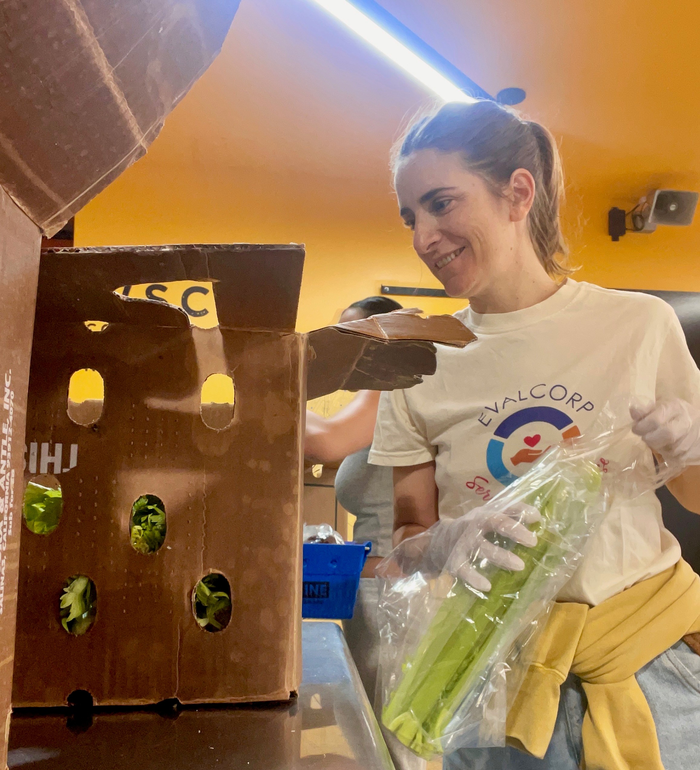 Mariana packing boxes of produce