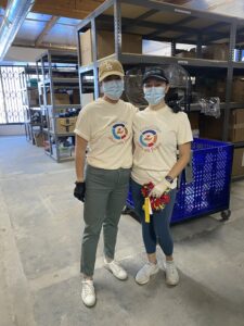 Team members in t-shirts with "Service with Purpose" logos volunteering for housing program